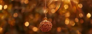 a glistening, rare seventeen mukhi rudraksha hanging from a golden chain, bathed in soft, ethereal light.