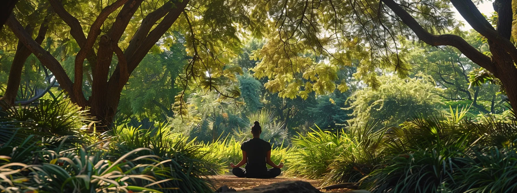 a person meditating in a serene natural setting, surrounded by lush greenery and a clear blue sky, embodying peace and emotional balance during a kundalini awakening.